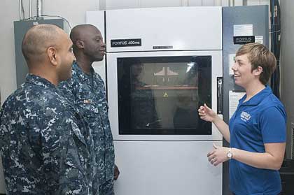 VIRGINIA BEACH, Va. (June 26, 2014) Carolyn Lambeth, a mechanical engineer at Combat Direction Systems Activity, right, explains the process on addictive manufacturing and 3D printing to Sailors during the U.S. Navy's first Maker Faire titled "Print the Fleet." The event showcased additive manufacturing techniques for Sailors and other stakeholders attending the two-day event. U.S. Navy photo by MCSN Jonathan B. Trejo