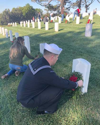 SAN DIEGO (Dec. 15, 2018) Cryptologic Technician (Collections) Second Class Richard Baray, attached to Information Warfare Training Command San Diego, lays a wreath on the grave of a fallen service member at Fort Rosecrans National Cemetery during a Wreaths Across America event. U.S. Navy photo by Chief Cryptologic Technician (Collections) Zachary Schulz