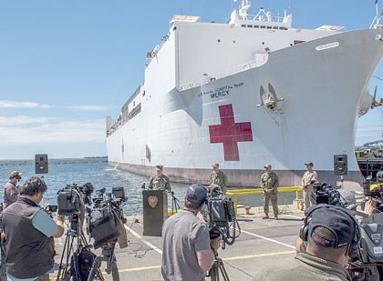 SAN DIEGO (March 23, 2020) Rear Adm. Timothy Weber, commander of Naval Medical Forces Pacific, speaks to members of the press before the Military Sealift Command hospital ship USNS Mercy (T-AH 19) departs Naval Base San Diego, March 23, 2020. Mercy deployed in support of the nation's COVID-19 response efforts, and will serve as a referral hospital for non-COVID-19 patients currently admitted to shore-based hospitals. This allows shore base hospitals to focus their efforts on COVID-19 cases. One of the Department of Defense's missions is Defense Support of Civil Authorities. DOD is supporting the Federal Emergency Management Agency, the lead federal agency, as well as state, local and public health authorities in helping protect the health and safety of the American people. U.S. Navy photo by MC1 David Mora Jr.