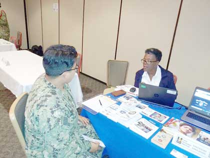 BANGOR, Wa. (August 19, 2019) Navy College Program Counselor Angela Ingram (right) introduces a Sailor to the resources and benefits available through Voluntary Education (VOLED) programs at a Career Development Symposium at Naval Base Kitsap. The VOLED Department is responsible for the oversight and administration of the off-duty VOLED programs such as Tuition Assistance, the Advance Education Voucher, Graduate Education Voucher, and Navy College Program for Afloat College Education. US Navy photo by NCC(SW/NAC/AW/IW) Kristie Freeman.