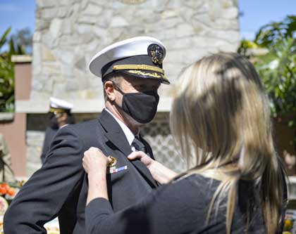 (March 24, 2021) Capt. Ted Carlson is pinned with the U.S. Navy Command Ashore insignia at the Naval Base San Diego change of command ceremony. On March 24, 2021 Naval Base San Diego held a change of command ceremony where Capt. Ted Carlson relieved Capt. Mark Nieswiadomy of command for Naval Base San Diego. U.S. Navy photo by MC2 Austin Haist.