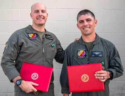 U.S. Marine Corps Capt. Steven Maire, left, an AH-1Z Viper pilot and a native of Cleveland, Ohio, and Capt. Joseph Carey, an MV-22B Osprey and a native of Hanover, New Hampshire, both assigned to Marine Medium Tiltrotor Squadron (VMM) 165 (Reinforced), 15th Marine Expeditionary Unit, pose for a photo after receiving Navy and Marine Corps Commendation Medals during a ceremony at Marine Corps Air Station Miramar, California, June 10, 2024. Maire and Carey were presented awards for providing lifesaving aid to a man suffering a medical emergency May 23, 2024, at Dallas Fort Worth International Airport. (U.S. Marine Corps photo by Cpl. Amelia Kang)