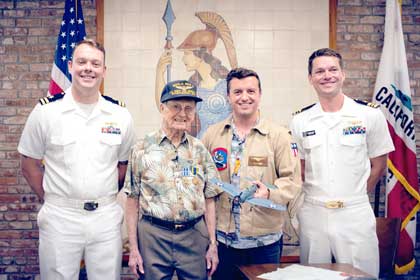 SACRAMENTO, Calif. (July 25, 2024) (Right to Left) Lt. Cmdr. Brantley Harvey, Naval Aviator and executive officer of Navy Reserve Center Sacramento, George Retelas, Richard E. Miralles and a U.S. Navy Lt. pose for a photo after an award ceremony honoring Miralles at the California State Capitol Building, July 25, 2024. Eighty-one years after serving as an Aviation Radioman-gunner in World War II 99-year-old Miralles received a Distinguished Flying Cross and an Air Medal for meritorious achievement in aerial flight during 85 combat missions as an Aviation Radioman 2nd Class from 16 August 1942 to 25 July 1943. Courtesy Photo by Jolie Orban.