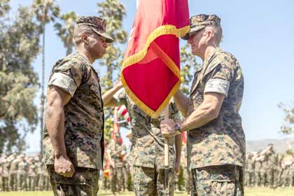 U.S. Marine Corps Brig. Gen. Jason G. Woodworth, right, outgoing commanding general passes the colors to Brig. Gen. Nick I. Brown, left, incoming commanding general of Marine Corps Installations West Marine Corps Base Camp Pendleton during a change of command ceremony at MCB Camp Pendleton, June 27. USMC photo by Lance Cpl. Mhecaela Watts